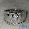 "925 Sterling Silver Ring with dramatic teardrop cubic set in middle of many cubics in a v shape"