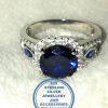 "925 sterling Silver Ring with Large Sqaure Middle Blue Cubic and 2 small blue leave shape with 2 clear cubic bands on top as 1 ring"