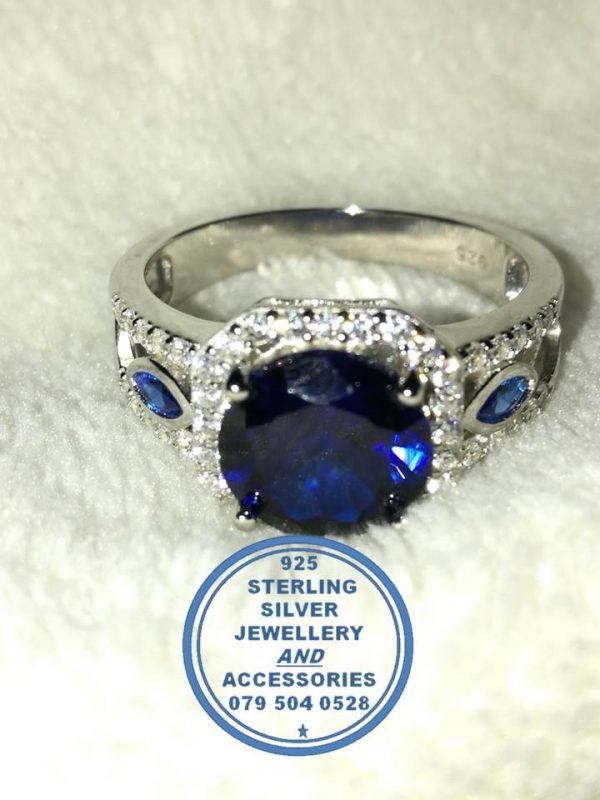 "925 sterling Silver Ring with Large Sqaure Middle Blue Cubic and 2 small blue leave shape with 2 clear cubic bands on top as 1 ring"