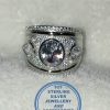 "925 Sterling Silver Ring with large cubic oval in middle with 2 teardrop cubics 1 on each side broad ring"