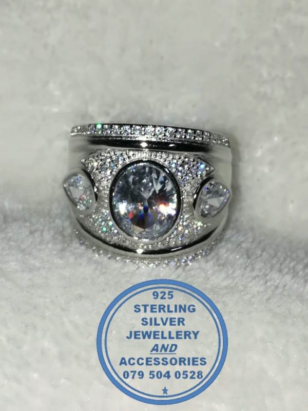 "925 Sterling Silver Ring with large cubic oval in middle with 2 teardrop cubics 1 on each side broad ring"